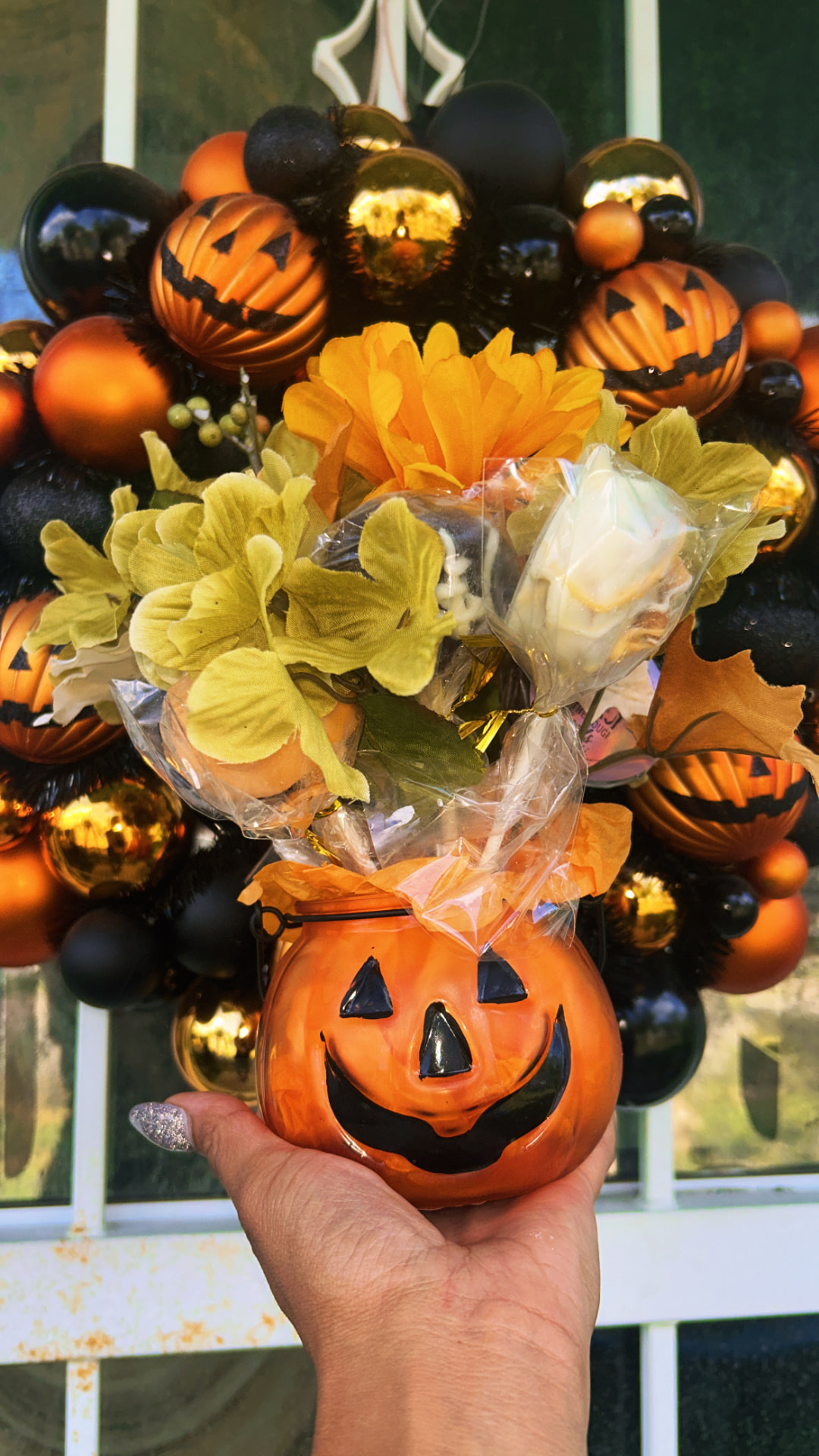 Jack-o-lantern boo basket filled with cake pops and rice krispies treats