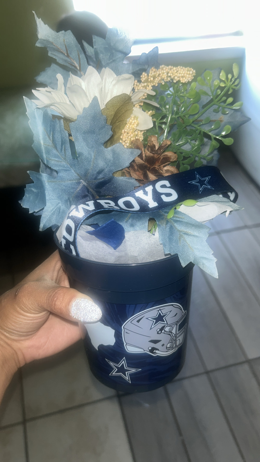 Dallas Cowboys themed treat basket with florals